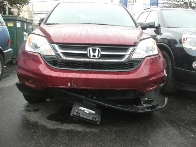 A red CRV with a broken bumper got from a car accident
