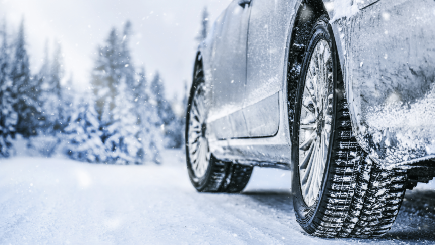 Image of car driving on snow covered road with winter tires